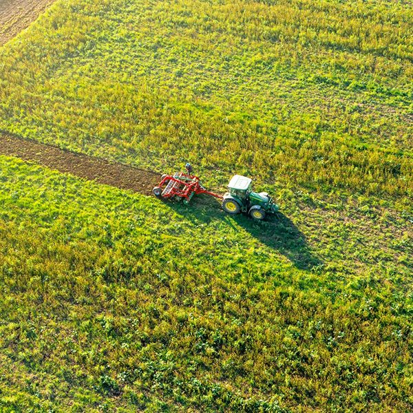 madre terra bio - cura di sè_0004_tractor-mowing-green-field-aerial-view-agriculture